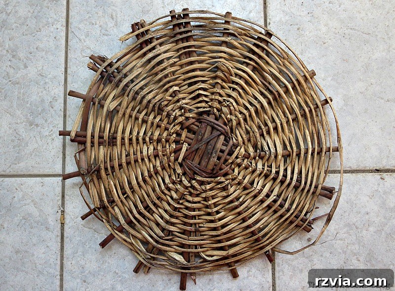 Close-up of the bottom section of an old, broken wicker basket.