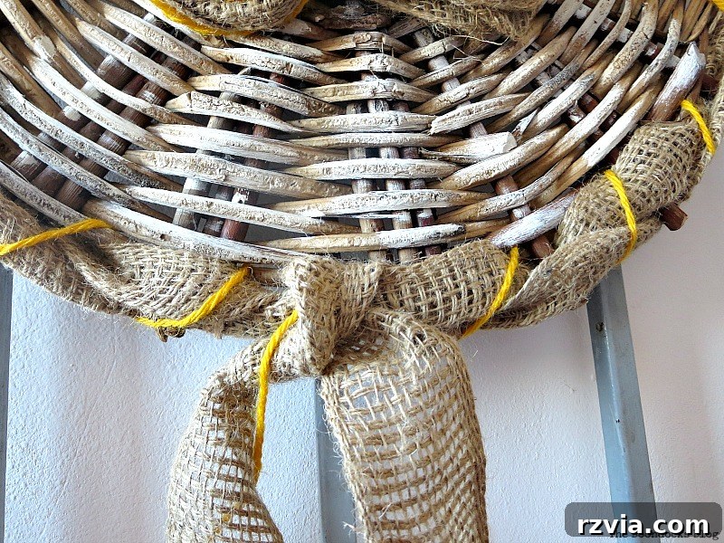 Shabby Chic Wicker Basket Revival 10 Knotting the ends of the burlap and yarn on the back of the wicker piece.