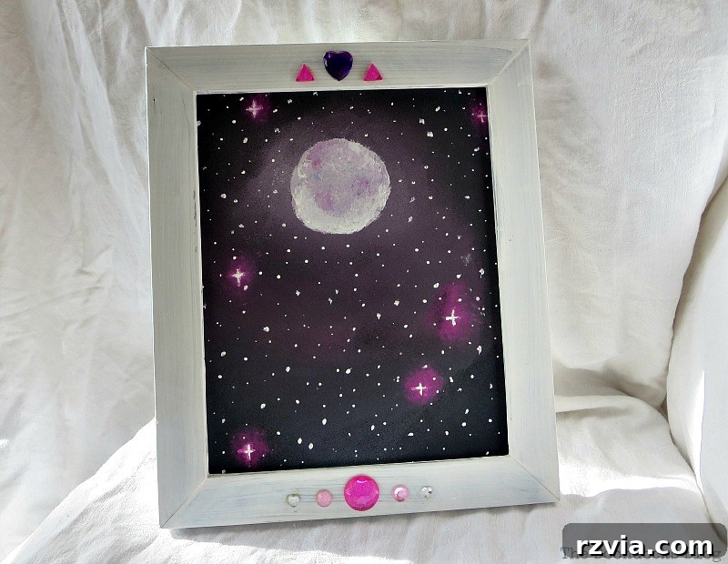 The completed picture frame with the 'Stars and Moon' galaxy painting beautifully inserted, a DIY masterpiece from www.theboondocksblog.com