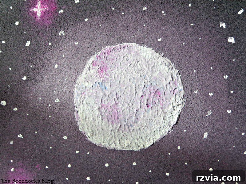 A close-up view of the moon within the galaxy painting, showcasing intricate details and colors, part of The Stars and Moon project on www.theboondocksblog.com