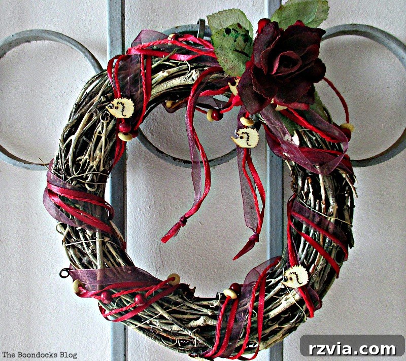 The repurposed white wreath with hedgehog ribbon, previously used for spring decor