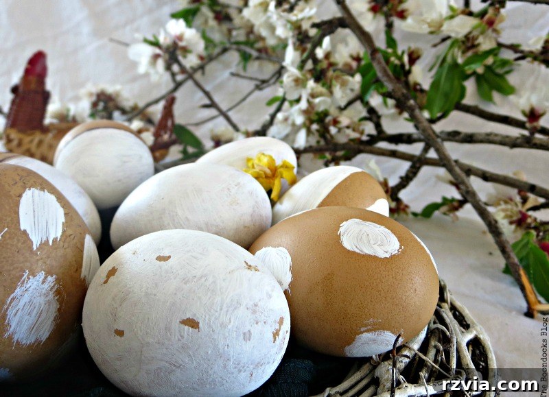 Artistically decorated rustic brown eggs nestled in the velvet-lined wreath