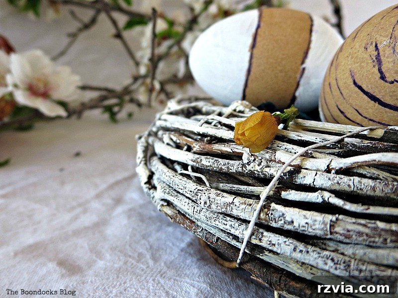 Close-up of the painted wreath branches showing rustic texture and imperfections