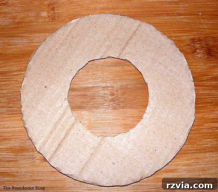 A donut-shaped cardboard base, ready to be transformed into a beautiful DIY spring wreath, showcasing a thrifty crafting approach.