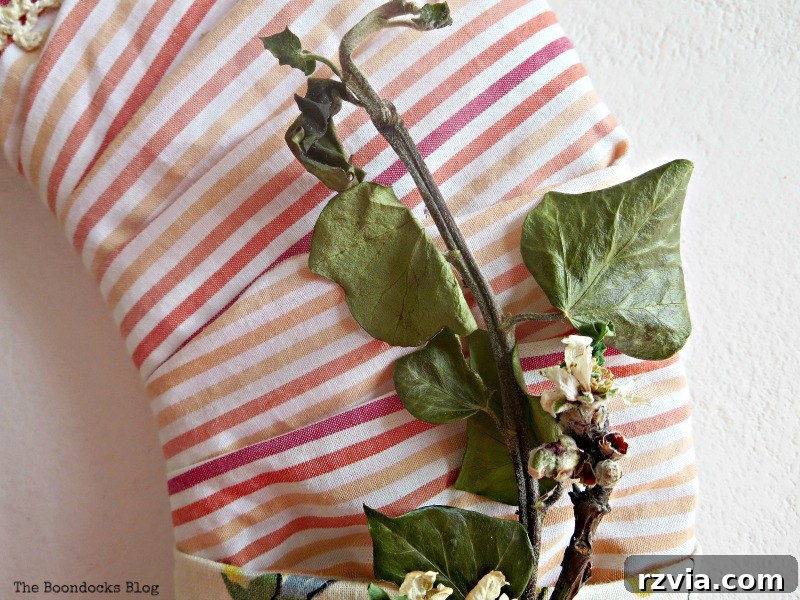 Repurposed striped fabric, cut into strips, ready to be incorporated into a DIY spring wreath, highlighting sustainable crafting.