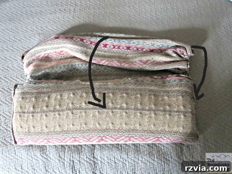 Quick & Cozy: DIY Sweater Pillows 11 The gathered bottom of a sweater being folded to create a pocket, enclosing the internal stuffing for the DIY pillow.