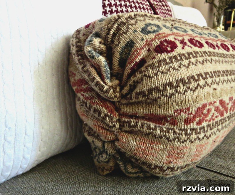Quick & Cozy: DIY Sweater Pillows 13 The beautifully gathered end of a finished DIY sweater pillow, showcasing the unique texture and design.