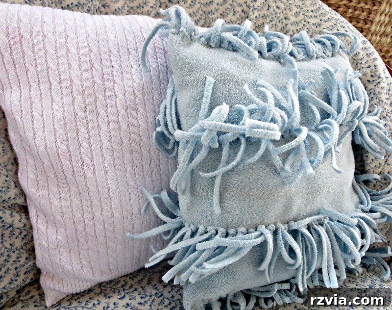 Quick & Cozy: DIY Sweater Pillows 5 A finished white sweater vest pillow displayed next to a fringed fleece scarf pillow, showcasing two easy DIY pillow creations for home decor.