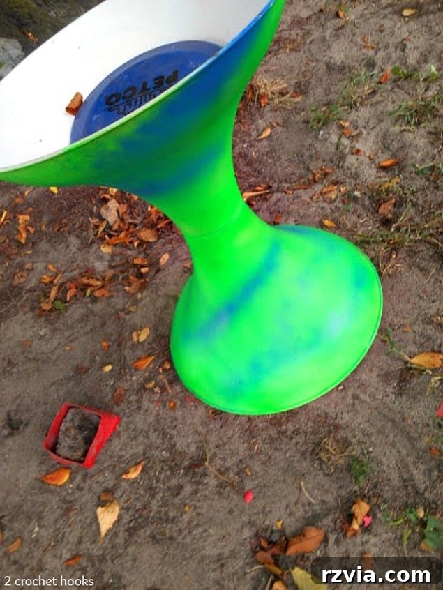 Craft Your Own Sea Glass Mosaic Table 4 The salvaged table base, now vibrantly painted in a neon green, hinting at its forthcoming transformation into a decorative piece.