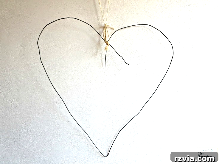 Sturdy wire meticulously bent into the classic shape of a heart, serving as the base for the wreath.