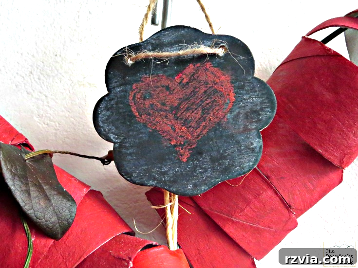 A charming mini-chalkboard sign delicately attached to the top of the red heart wreath, ready for a personalized Valentine's message.