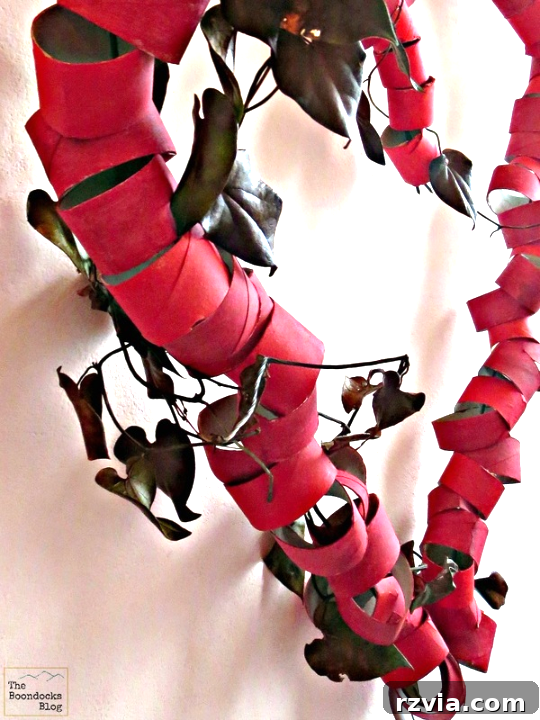 A close-up, side-angle view of the finished upcycled toilet paper roll heart wreath, highlighting its texture and depth.