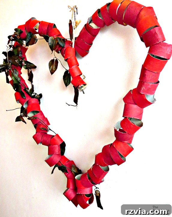 The completed oversized heart-shaped wreath proudly hanging on a wall, showcasing its significant size and visual impact.