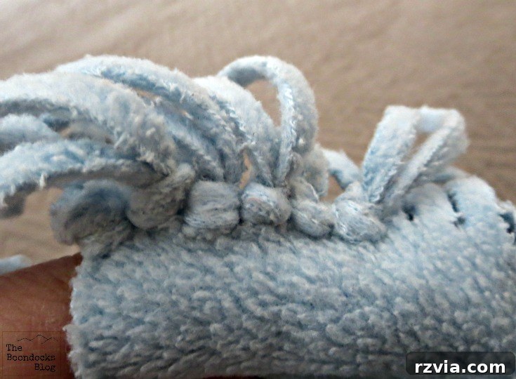 Effortless Fleece Pillow 6 Close-up of tied fringes on a fleece scarf, forming the pillow edge