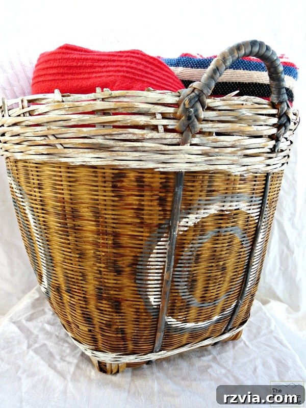 Front view of the beautifully painted and distressed wicker basket, now a stylish home decor piece