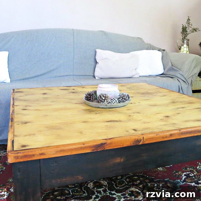 Vibrant Tri-Tone Reclaimed Coffee Table 2 Stunning refurbished coffee table with a rustic farmhouse aesthetic, showcasing a blonde wood top and dark painted legs