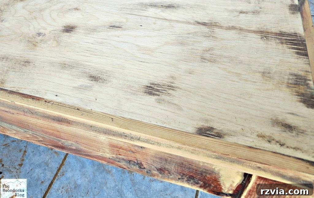 Vibrant Tri-Tone Reclaimed Coffee Table 6 Close-up showing the distinct difference in wood types between the coffee table's frame and its central top panel after sanding.