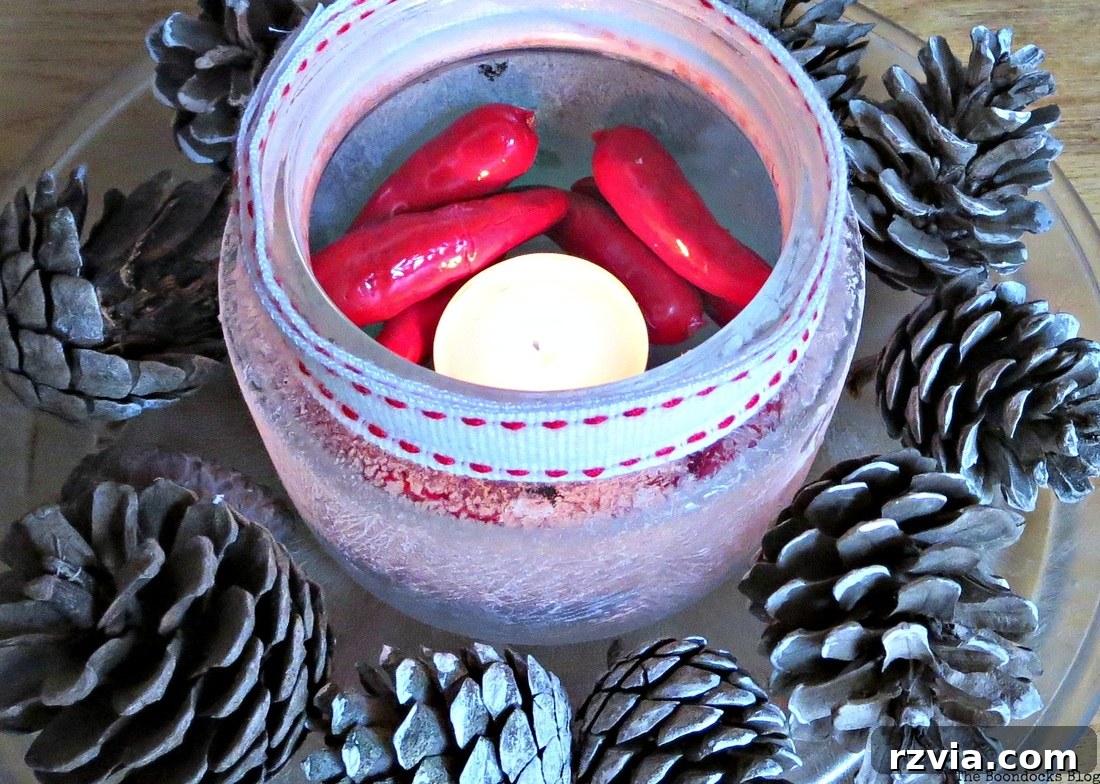 Phantom Snow 14 Tealight centerpiece with pine cones, decorative peppers, and crystal ice spray