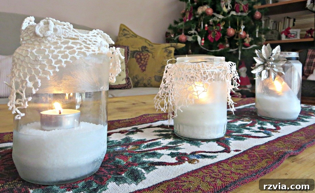 Phantom Snow 8 Three lit frosted tealight holders with lace, creating a warm, winter ambiance