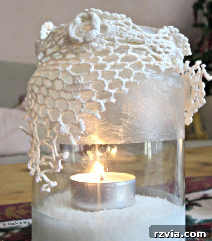 Phantom Snow 10 Lit frosted tealight holder with crochet lace, casting a warm ambient light