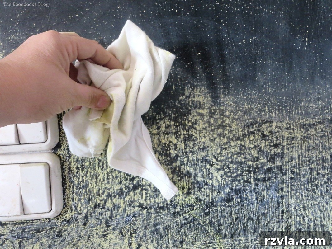 Craft Your Custom Chalkboard Wall 11 Blackboard wall with frame being properly seasoned using a piece of chalk held sideways to fill the surface pores. www.theboondocksblog.com