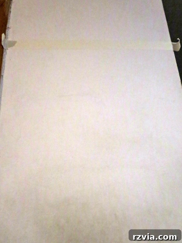 Craft Your Custom Chalkboard Wall 3 A dirty wall section, meticulously taped off and ready for the chalkboard transformation project. www.theboondocksblog.com