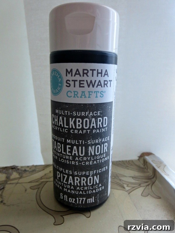 Craft Your Custom Chalkboard Wall 4 Open can of black chalkboard paint, ready for application to create a DIY chalkboard wall. www.theboondocksblog.com
