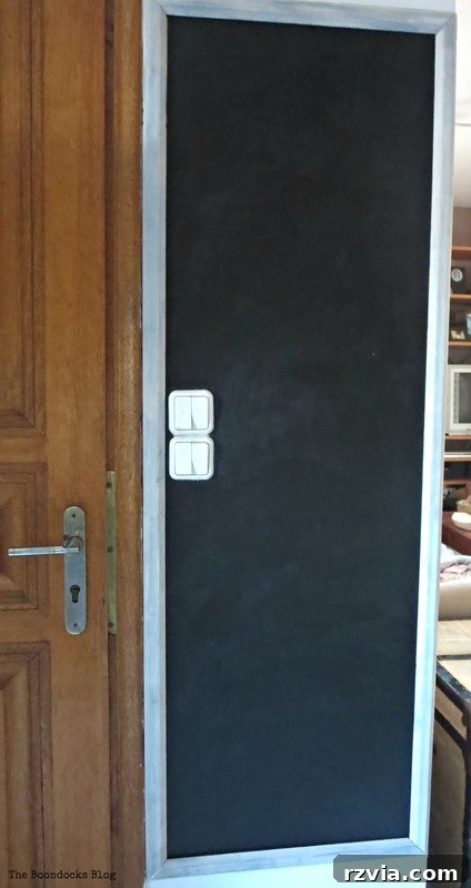 Craft Your Custom Chalkboard Wall 9 Newly painted blackboard wall with frame, undergoing the essential curing period before first use. www.theboondocksblog.com