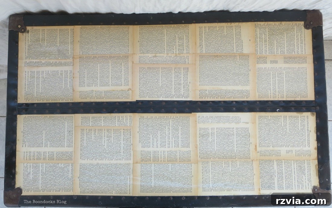 Top view of the decoupaged trunk, highlighting the book page arrangement and aged finish