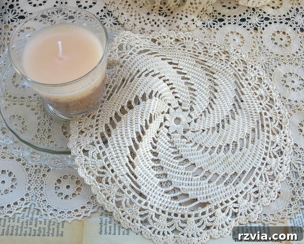 A candle and more doilies arranged inside the decoupaged vintage trunk, symbolizing cherished memories