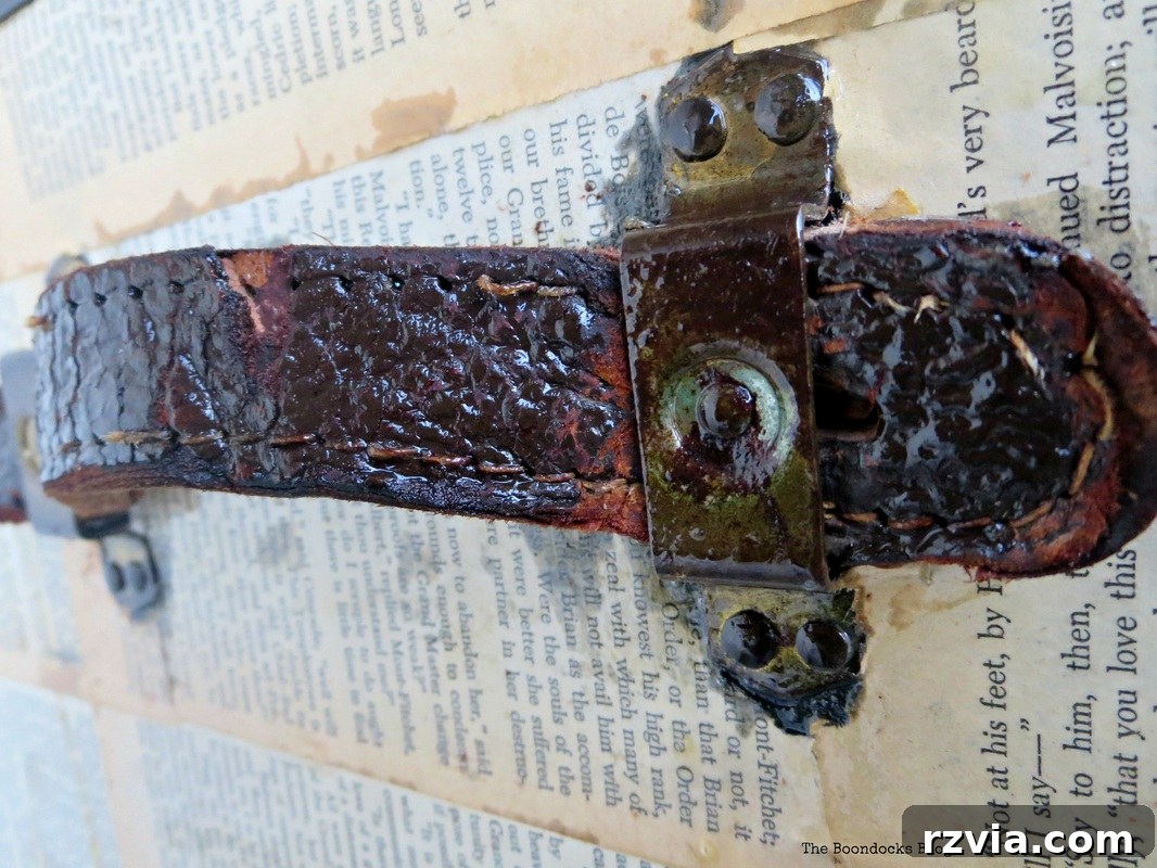 Close-up of the leather handle on the decoupaged trunk, treated with varnish for an aged patina
