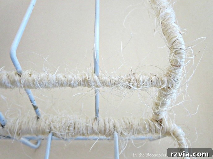 Close-up detail of two wire rack sections being wrapped and joined together with twine to create a rustic organizer. The Twine Lady Returns www.theboondocksblog.com