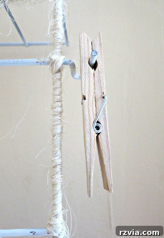Close-up of a clothespin holding an item on the twine-wrapped wire rack organizer, highlighting the rustic detail. The Twine Lady Returns www.theboondocksblog.com