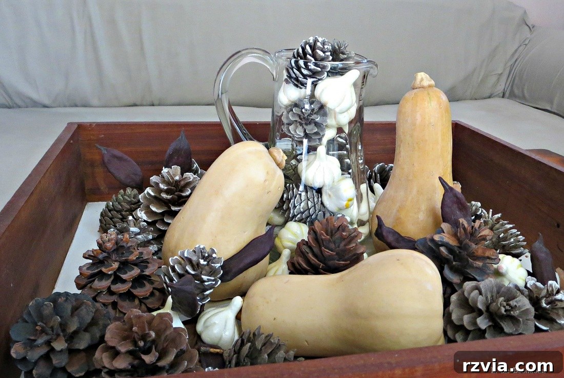 Mix of real pumpkins, pinecones, and fake squash in a fall display, www.theboondocksblog.com